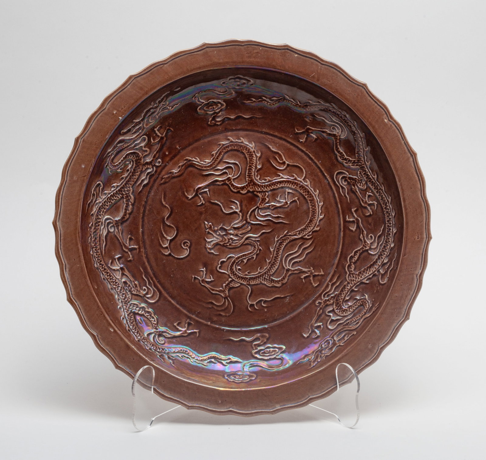 Lg Chinese Porcelain Charger: The charger interior carved with three-clawed dragons sinuous amidst flames and clouds, glazed in lustrous dark brown color, the exterior sides covered in even yellow-brown glaze. Approx. 11.8inch D.