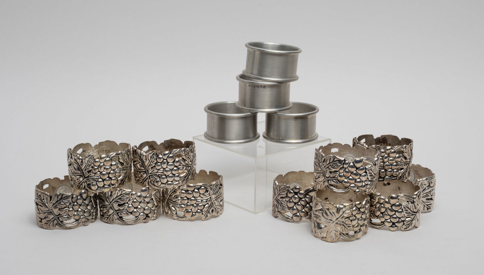 Large Set Vintage Napkin Rings: Including set of 16 napkin rings cast in grape form and set of 4 napkins etched Pewter. Size varies.