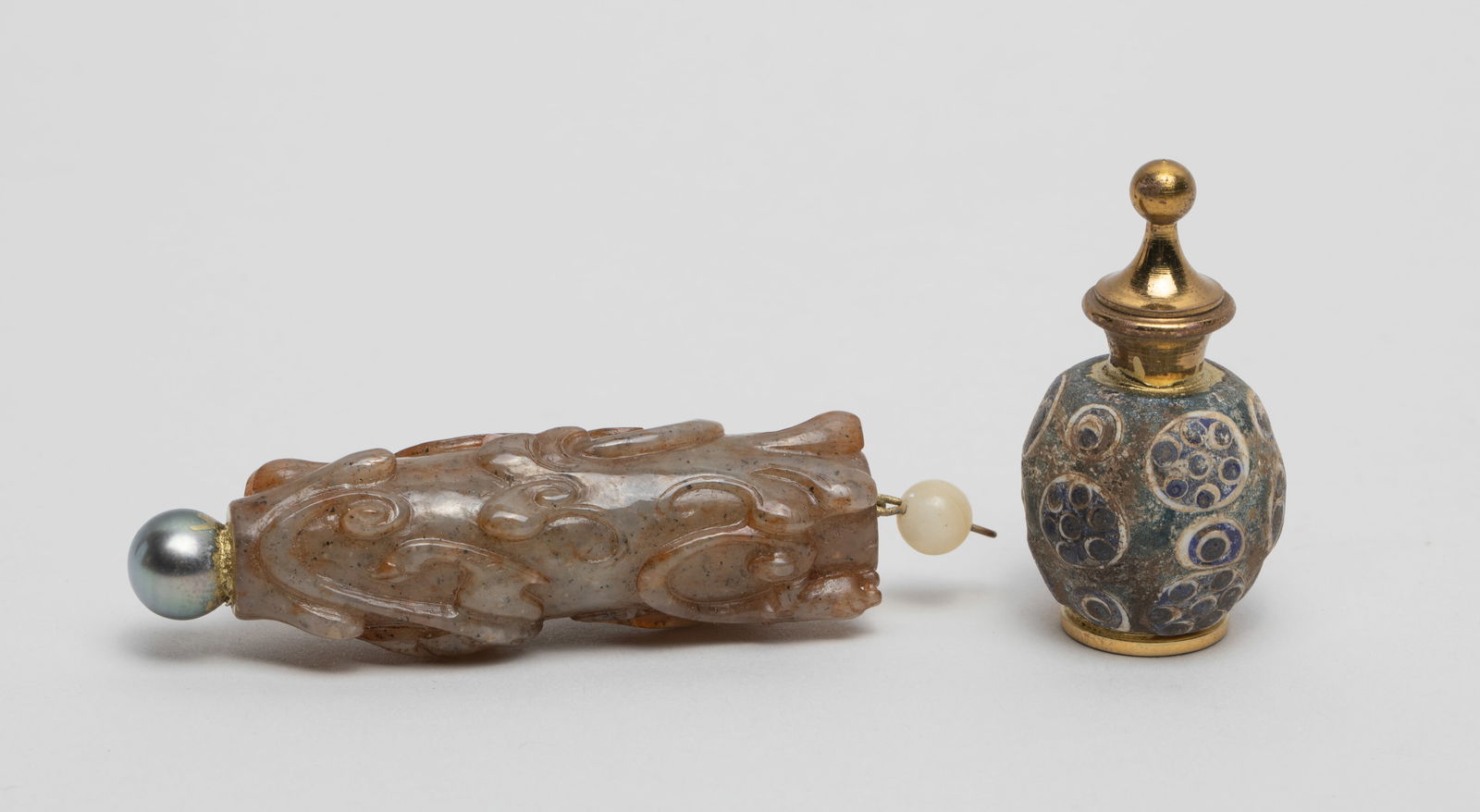 Chinese Jade & Dragonfly Eye Pins: Including a dragonfly eye glass bead pin, and a russet jade pin carved in high relief with sinuous beasts, with a pearl-like bead and a gemstone bead. Approx. 2.28*0.73 inch (jade size).