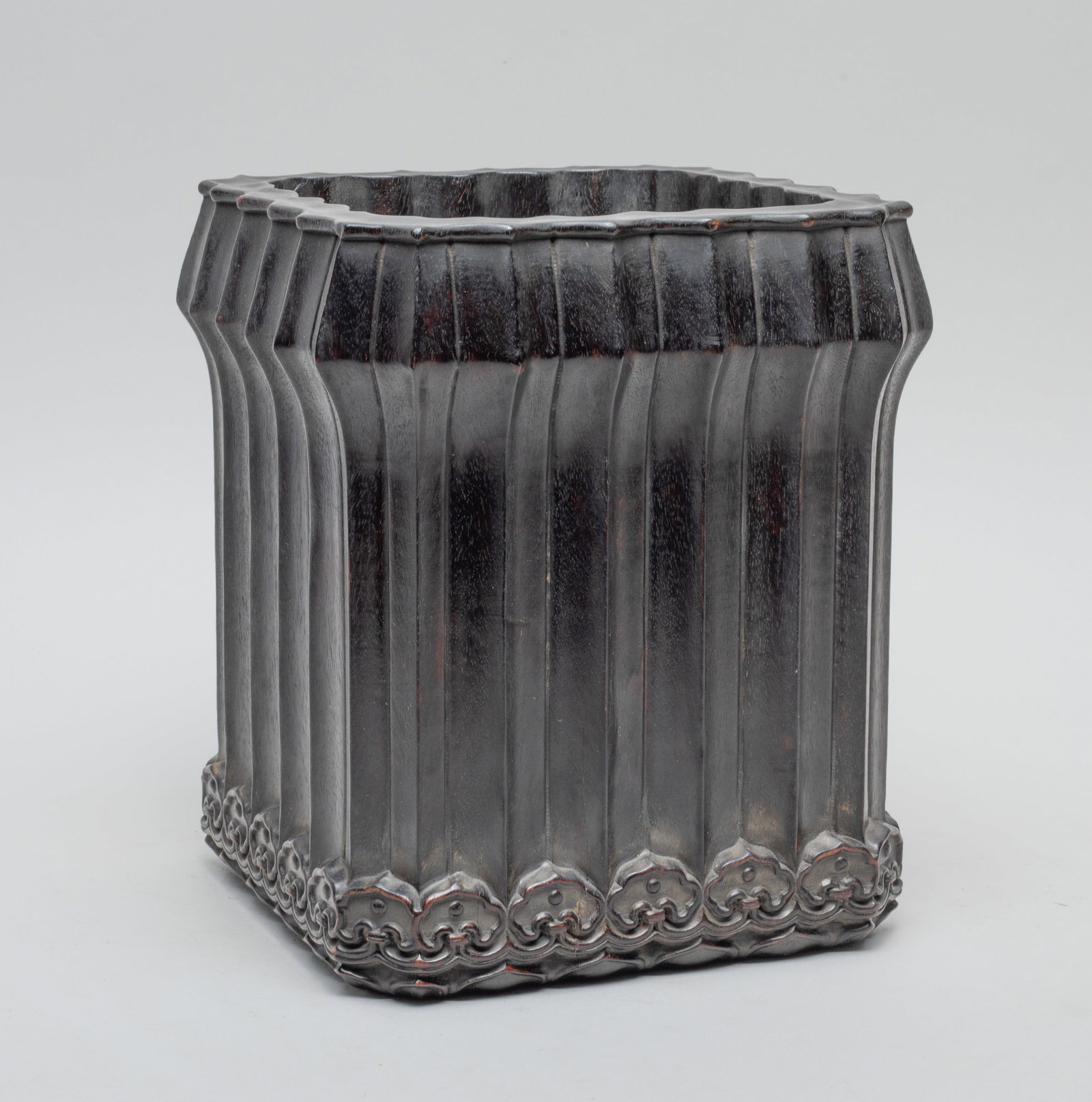 Chinese Hard Wood Brush Pot: The lobed body of tall square section, the foot carved with bands of ruyi heads and lotus petals. Approx. 7.2*6*6 inch.
