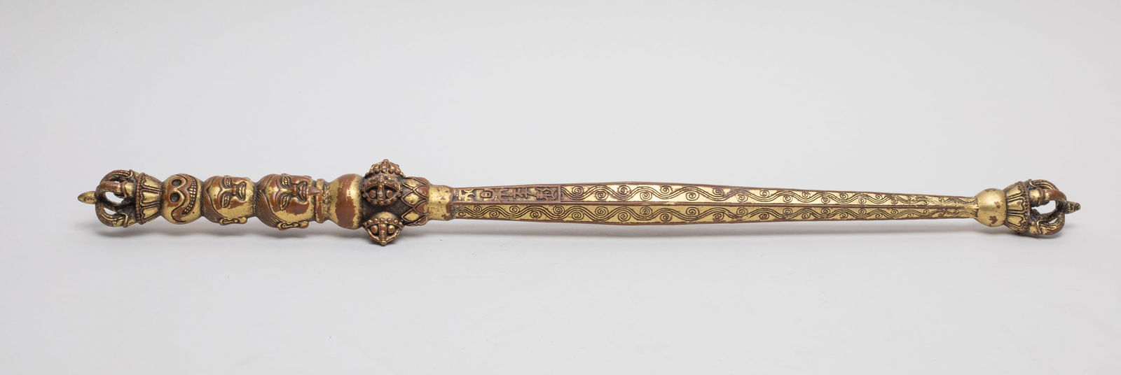 Chinese Sino-Tibetan Gilt Bronze Piece: Collectible Chinese Sino-Tibetan gilt bronze piece, cast with Buddha faces, lotus, Buddhist symbols and scroll motif. Approx. 19.1*1.75 inch.