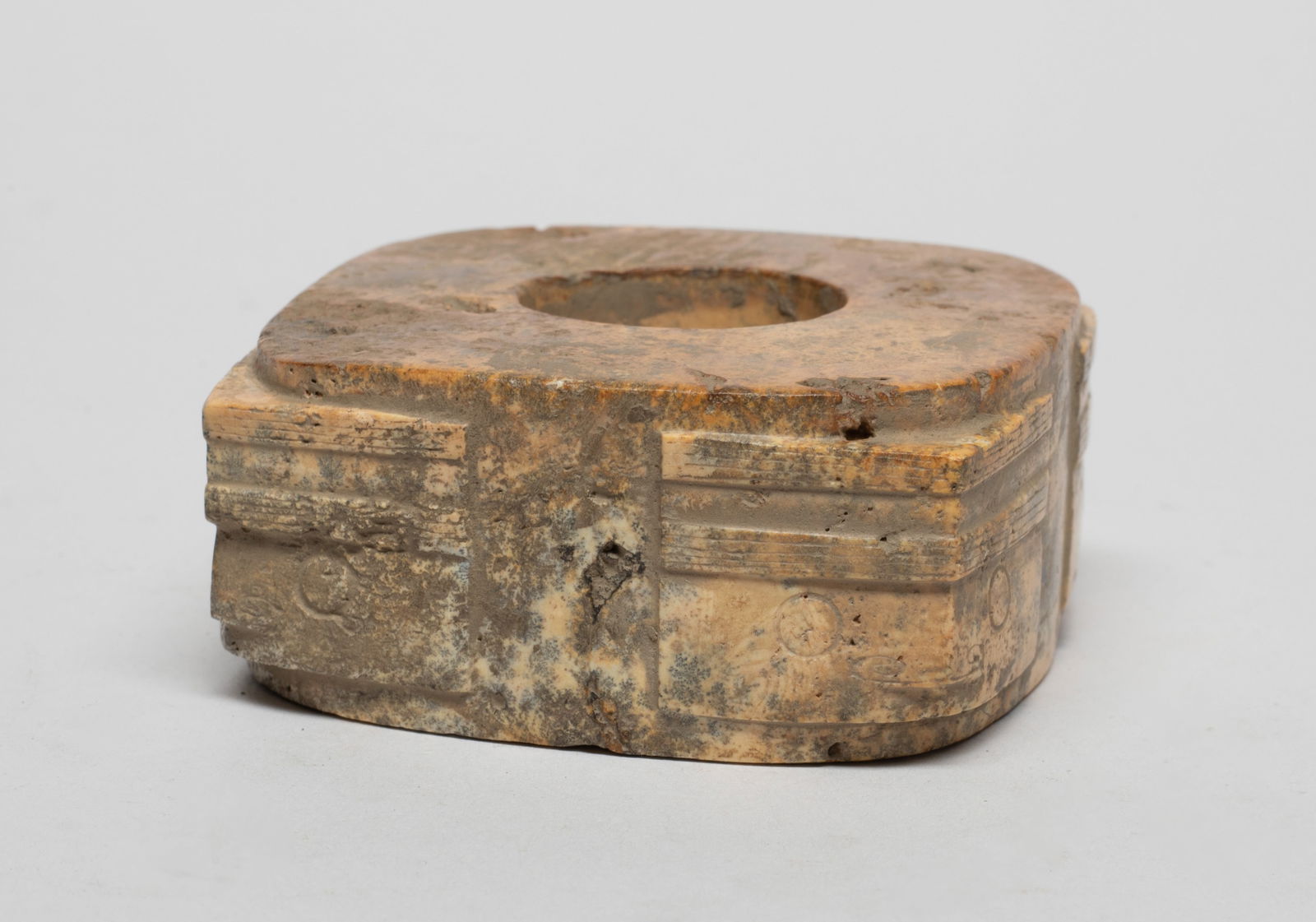 Chinese Chicken Bone Jade Cong: Th cong of short cylindrical square section, with masks detailed with fine lines carved below striated bands at each angled corner. Approx. 2.64*2.56*1.17 inch.