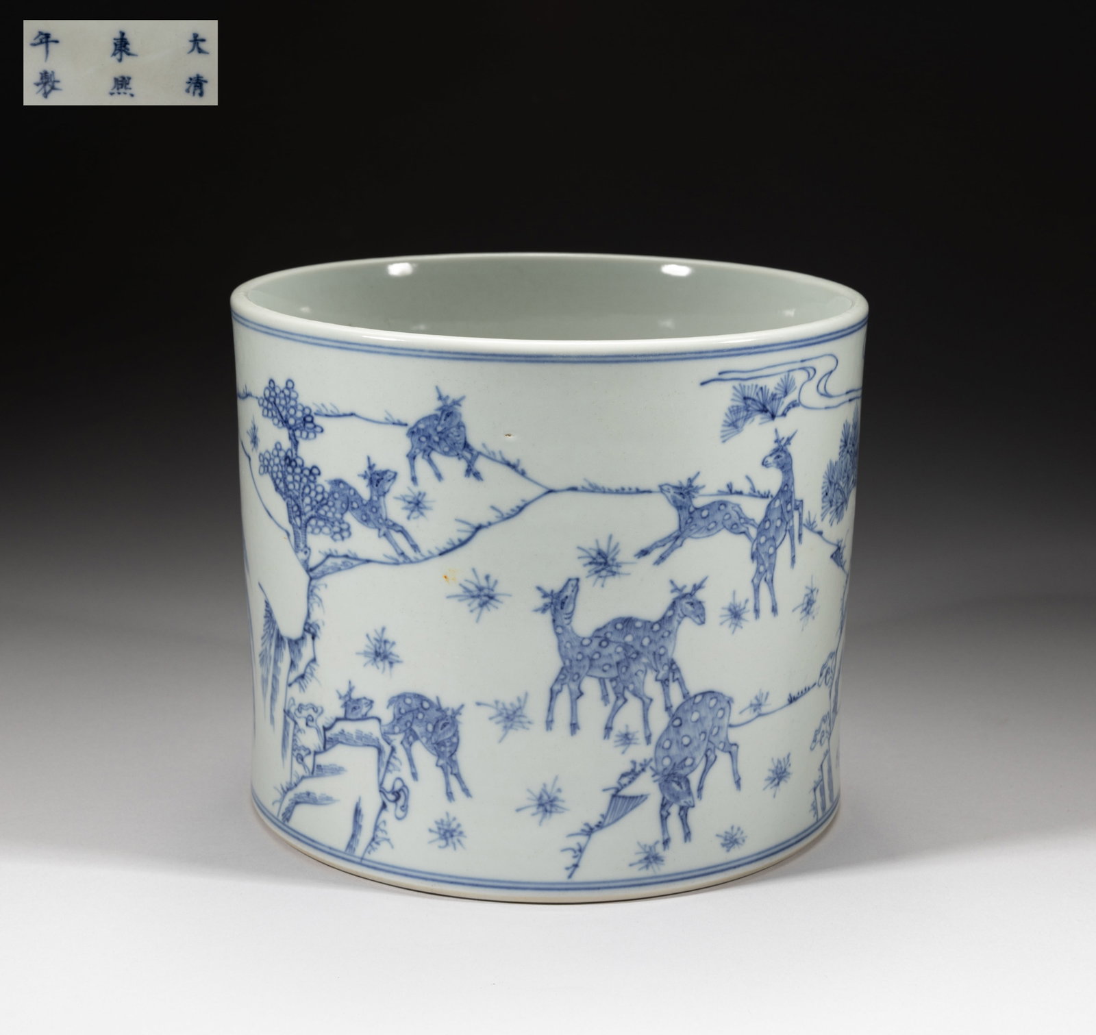 Chinese Blue & White Porcelain Brush Pot: Of cylindrical form, the exterior painted with deer in landscape with a pine tree and clouds, the bottom marked with six characters. Approx. 7.5*6.2 inch.