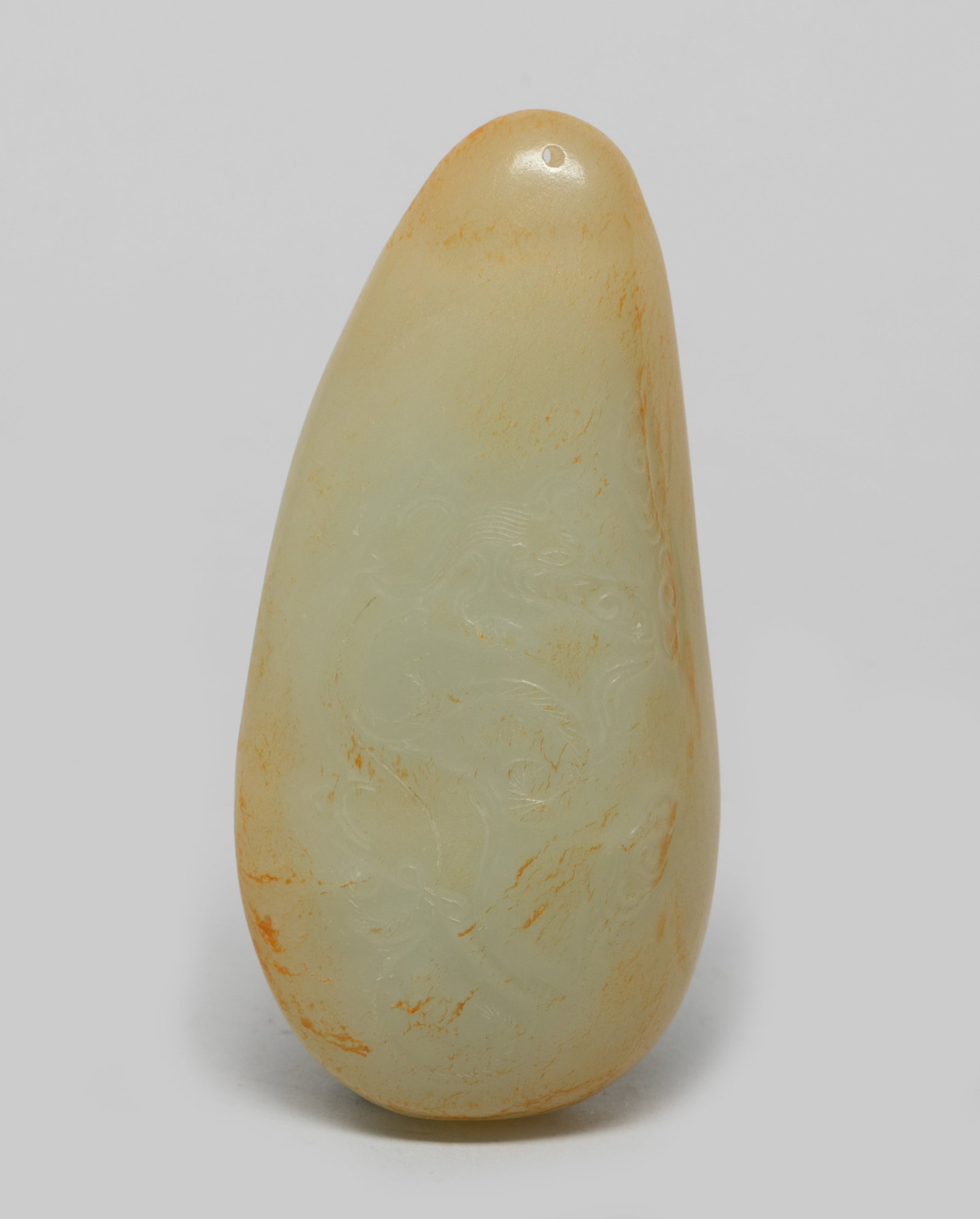Chinese Russet Jade Carving: Chinese russet jade pebble, carved on either side in low relief with a sinuous chilong and clouds. Approx. 3.45*1.67*0.84 inch.