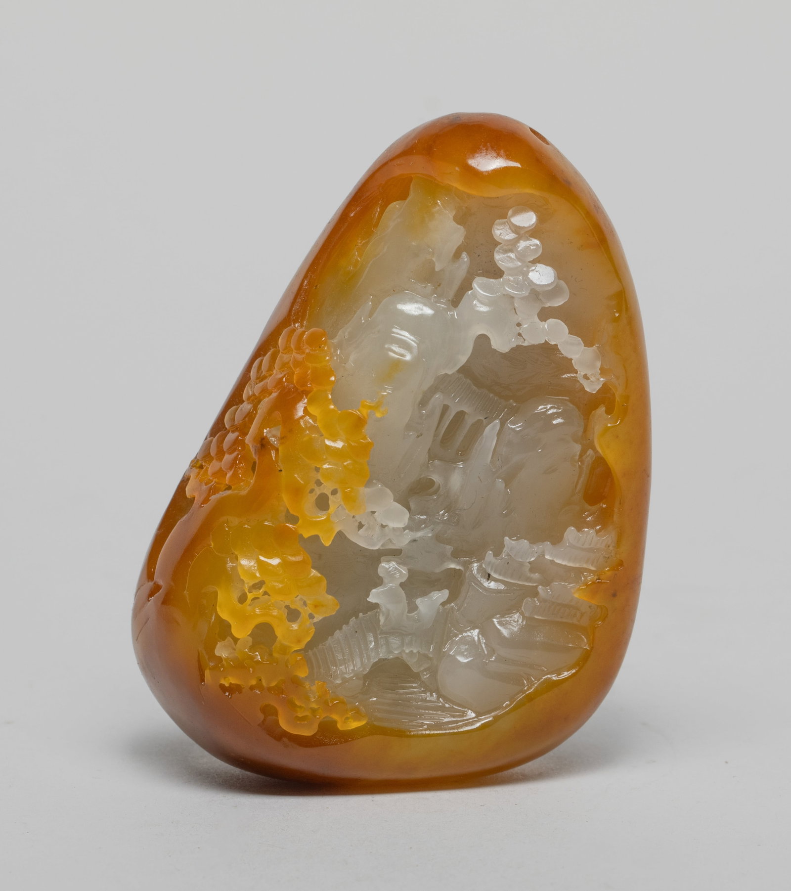 Chinese Russet Jade/ Stone Carving: Deftly carved in multiple layers of relief, the stone modeled as a serene mountainous landscape, with a scholar and his attendant crossing a bridge over a stream among trees. Approx. 3.3*2.3*1.3 inch.