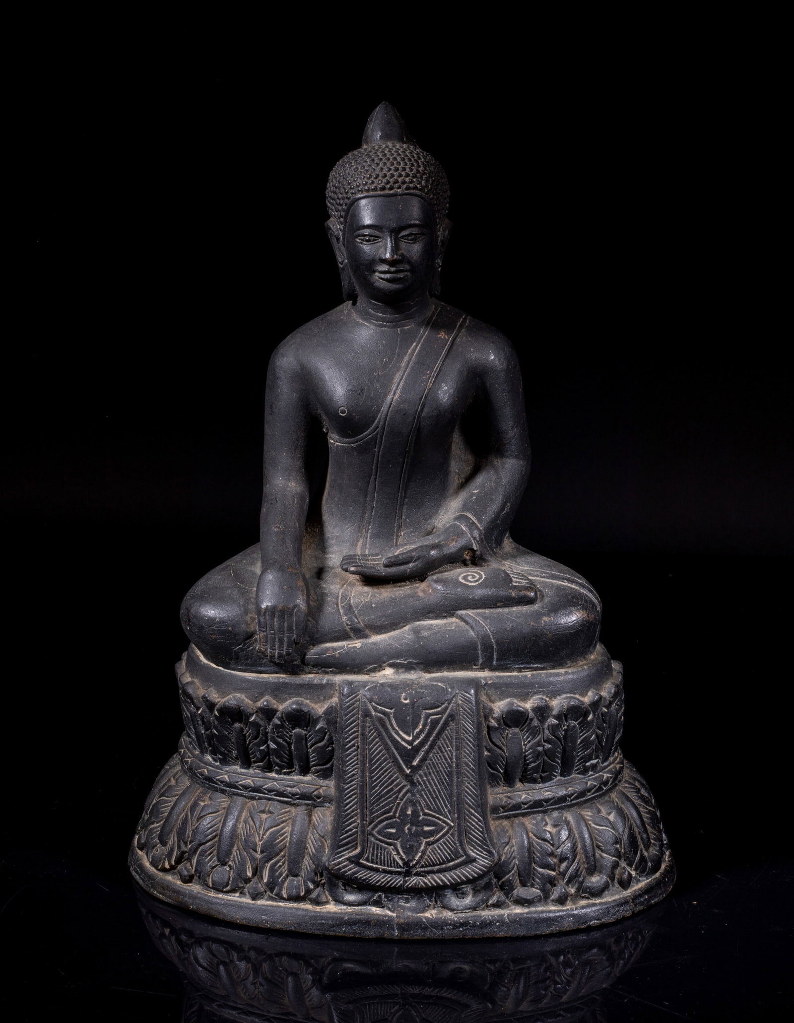 South Asian Bronze Buddha: Hollow bronze Buddha cast seated on double-layered lotus base, the base back incised with Buddhist characters, his right hand lowered in bhumisparsa mudra and his left hand resting palm upward in dhya