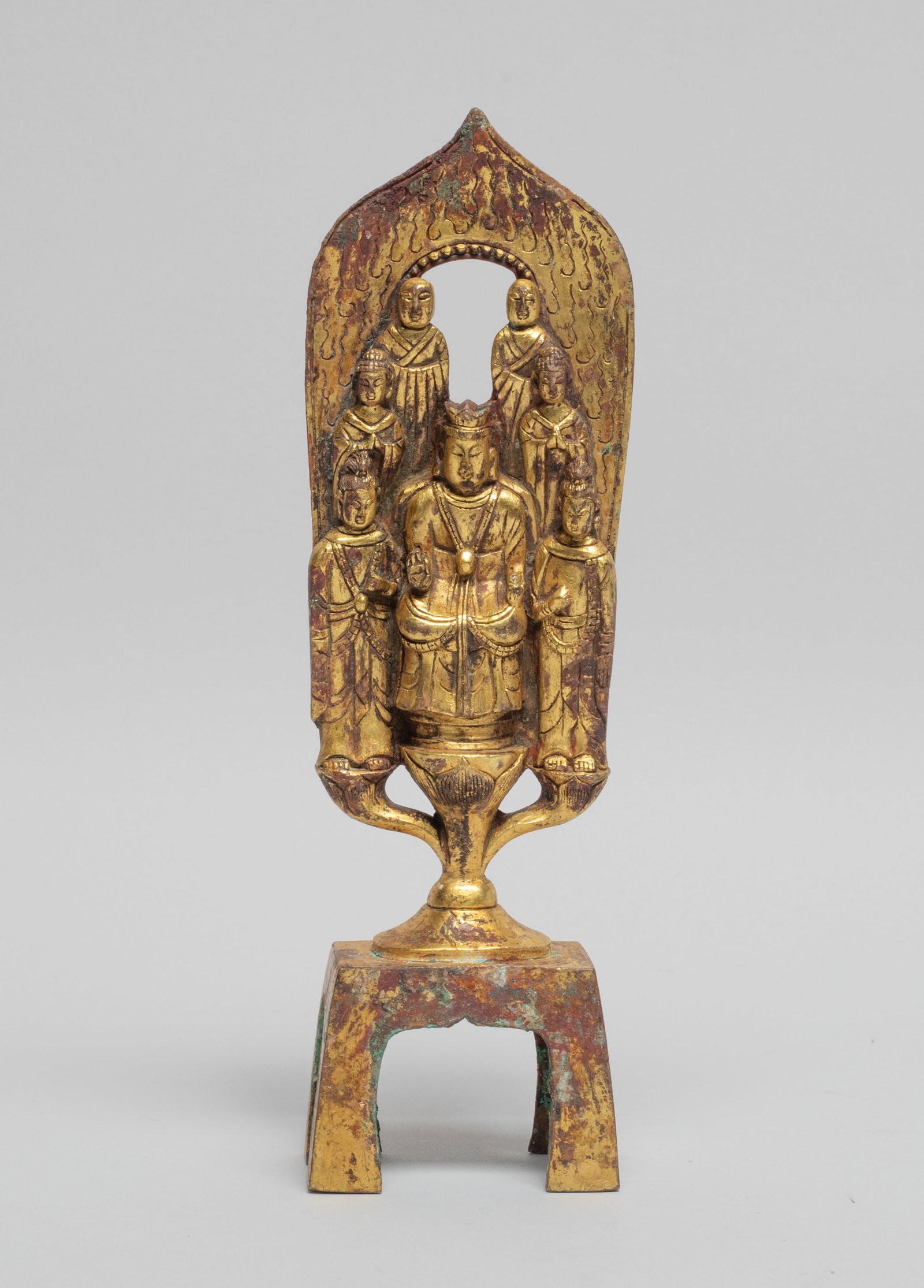 Chinese Gilt Bronze Buddha: The central Buddha seated on a lotus throne issuing from a pedestal, in front of a petal shaped flame, with six attendant Buddha standing aside. Approx. 6.3*1.8*1.1 inch.