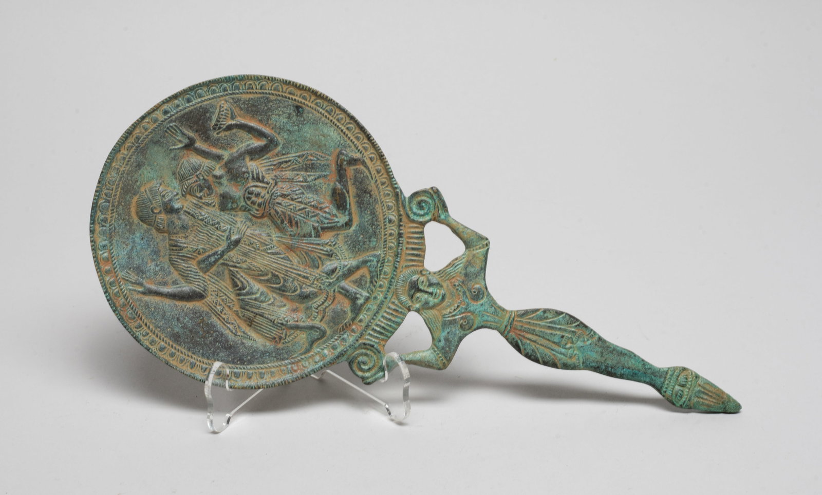 Collectible Greece Bronze Mirror: The mirror carved with two dancing figures, the handle cast in female form. Approx. 10*4.5 inch. The Estate of the Zoe & Liv. Hollywood.
