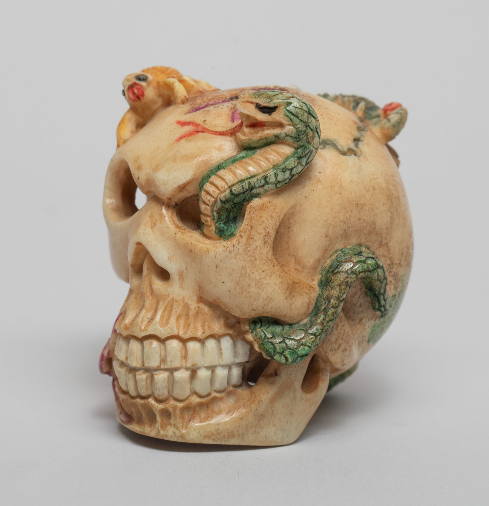 Vintage Japanese Carved Netsuke Skull: Vintage Japanese netsuke carved as skull with snake, scorpion, toad, centipede, and gecko. Approx. 2*1.95*1.7 inch.