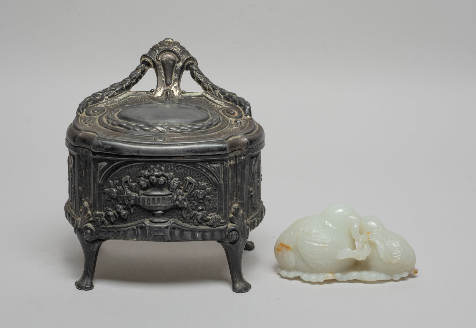 Chinese White Jade Carved Sculpture: The pebble meticulously carved as two two birds nestled beside each other, their beaks clasping together the same sprig, their finely detailed plumage and tail feathers crossing over intimately, the u