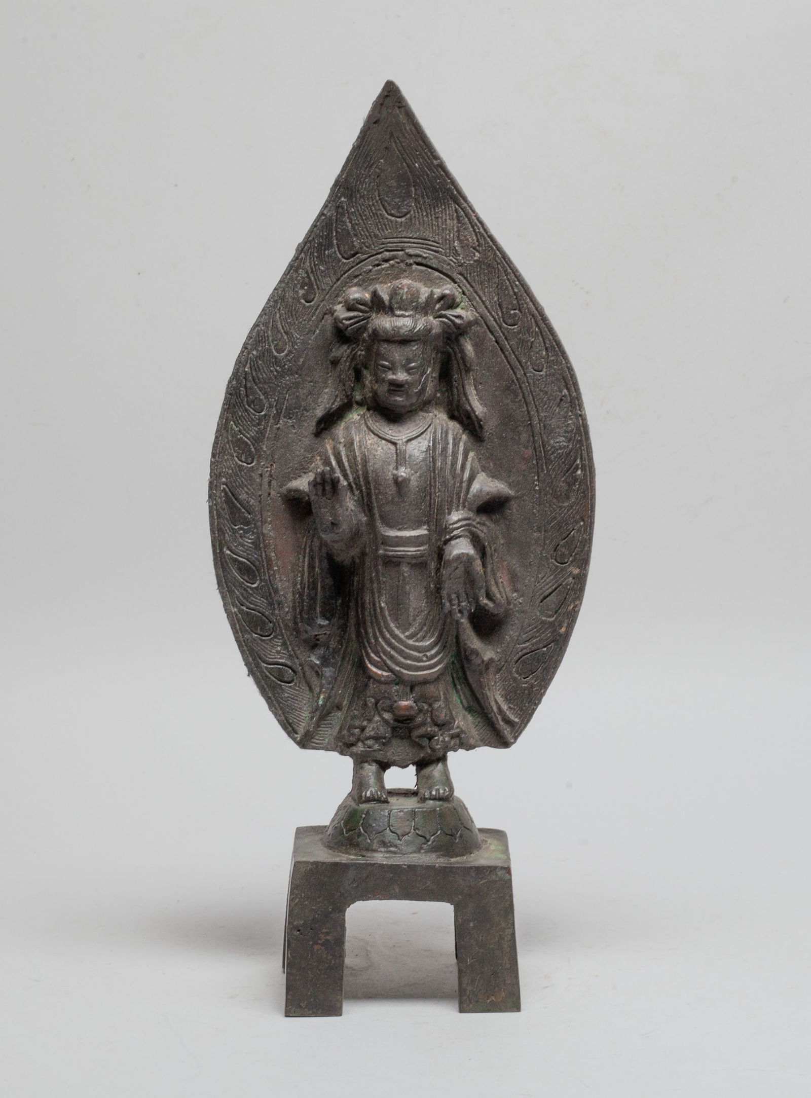 Special Form Chinese Bronze Buddha: The Buddha cast standing in front of flame-shaped halo on a lotus base and a square pedestal, dressed in a loose-fitting robe, the hands in abhaya mudra. Approx. 12.4*5.2*2.8 inch.