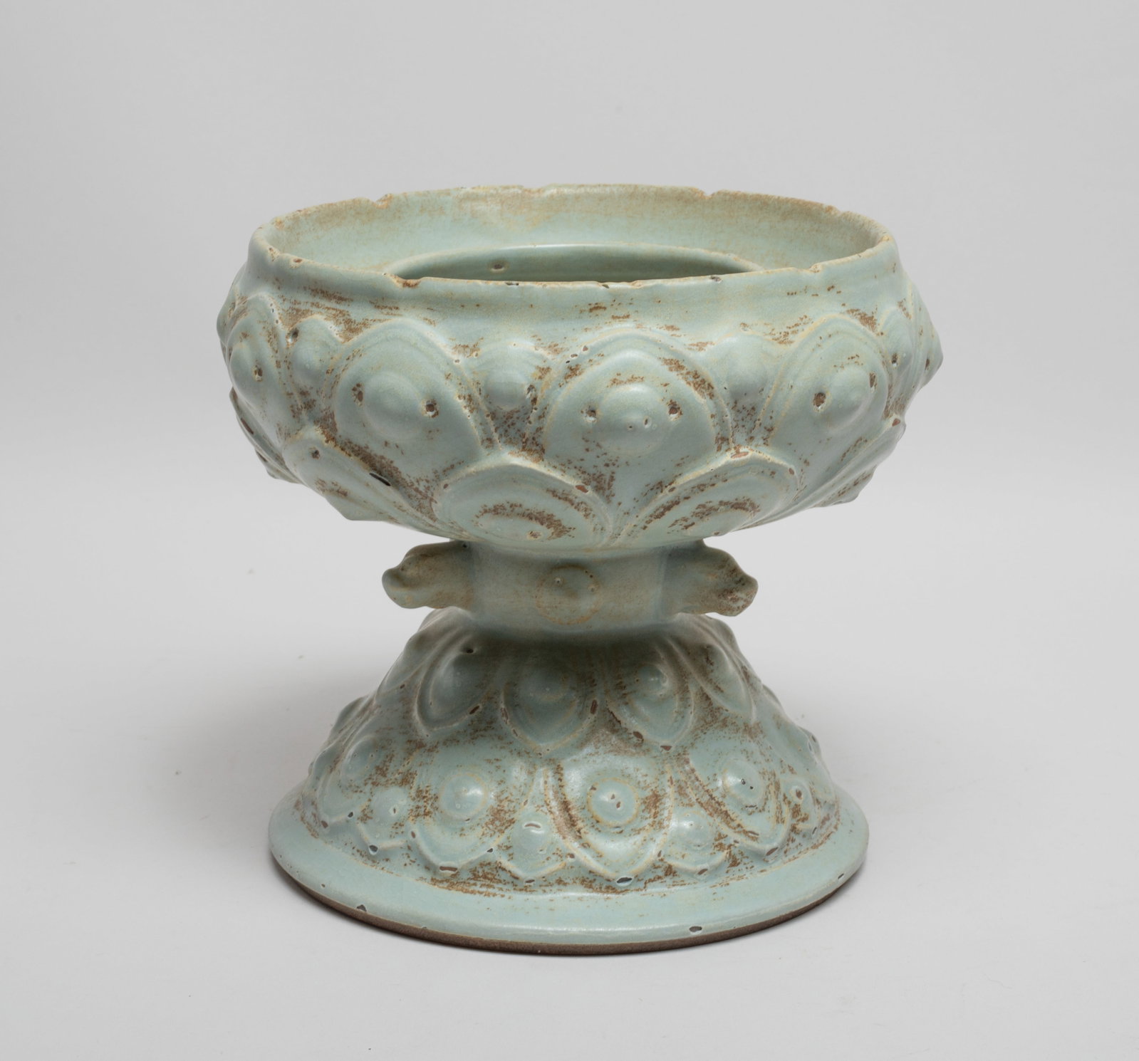 Large Chinese Export Porcelain Lotus Base: The compressed vessel resting on a spreading foot, the upper and lower section carved with overlapping lotus petals, the central waist set with three raised beast heads, overall covered in crackled pa
