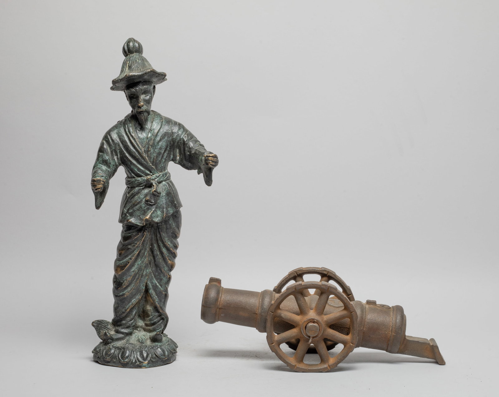 Tall France Metal Figure & Sculpture: Including a metal cannon sculpture and a metal standing man sculpture. Approx. 16*6*4.5 inch (man size). The Estate of the P. H. Yuen, Los Angeles