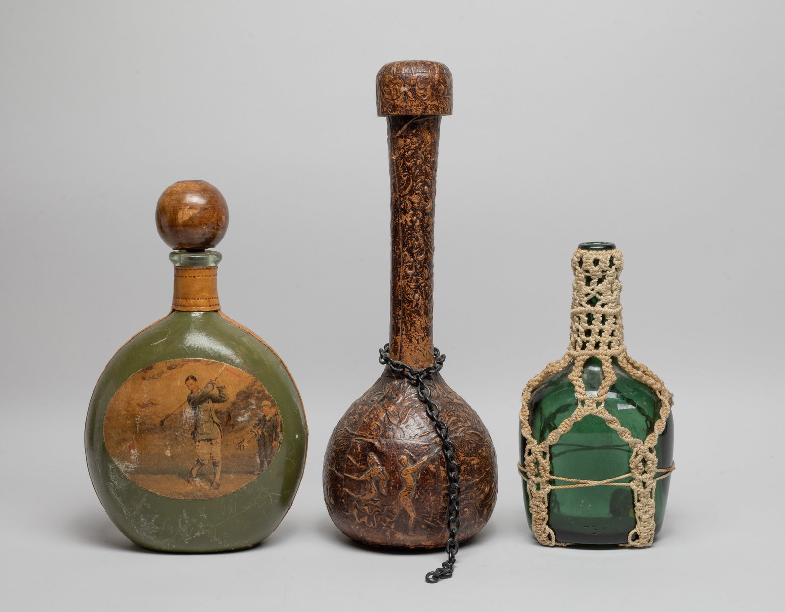 Estate Vintage Wine Bottles: Three vintage wine bottles, the tallest one carved with floral motif. Approx. 14.5*5.3 inch.