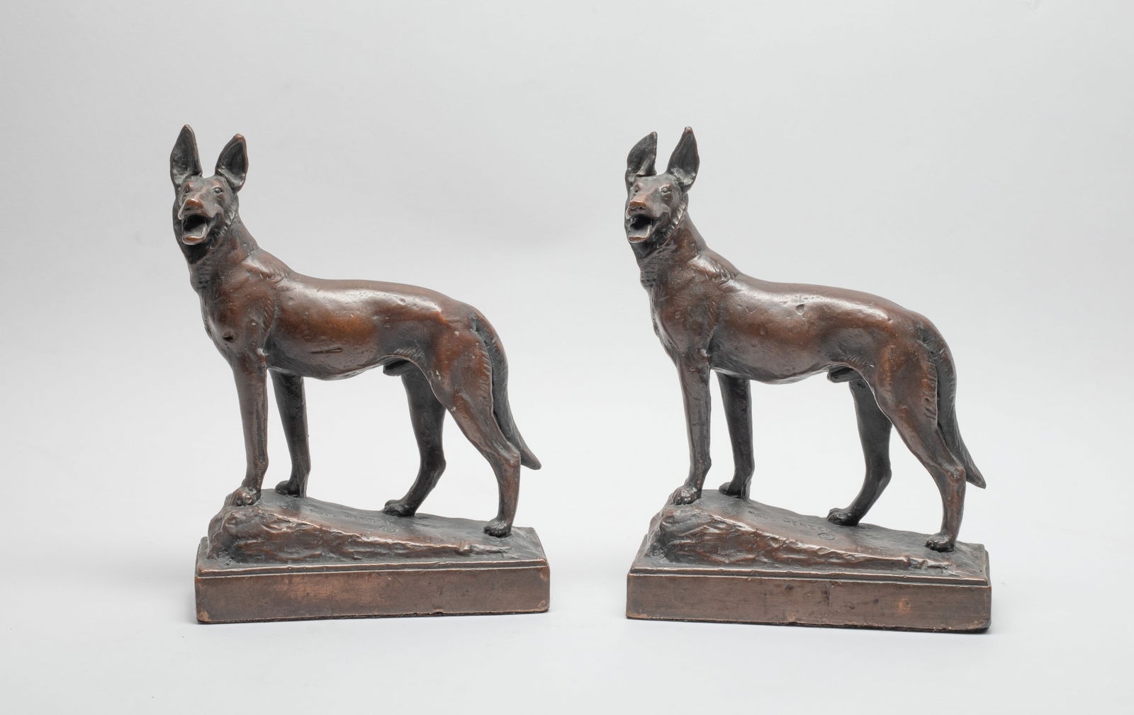 Paul Herzel Bronze Bookends of Dog: A pair of painted bronze bookends cast in wolf dog form, marked PAUL HERZEL. Approx. 8.6*6.2*2.2 inch (each).