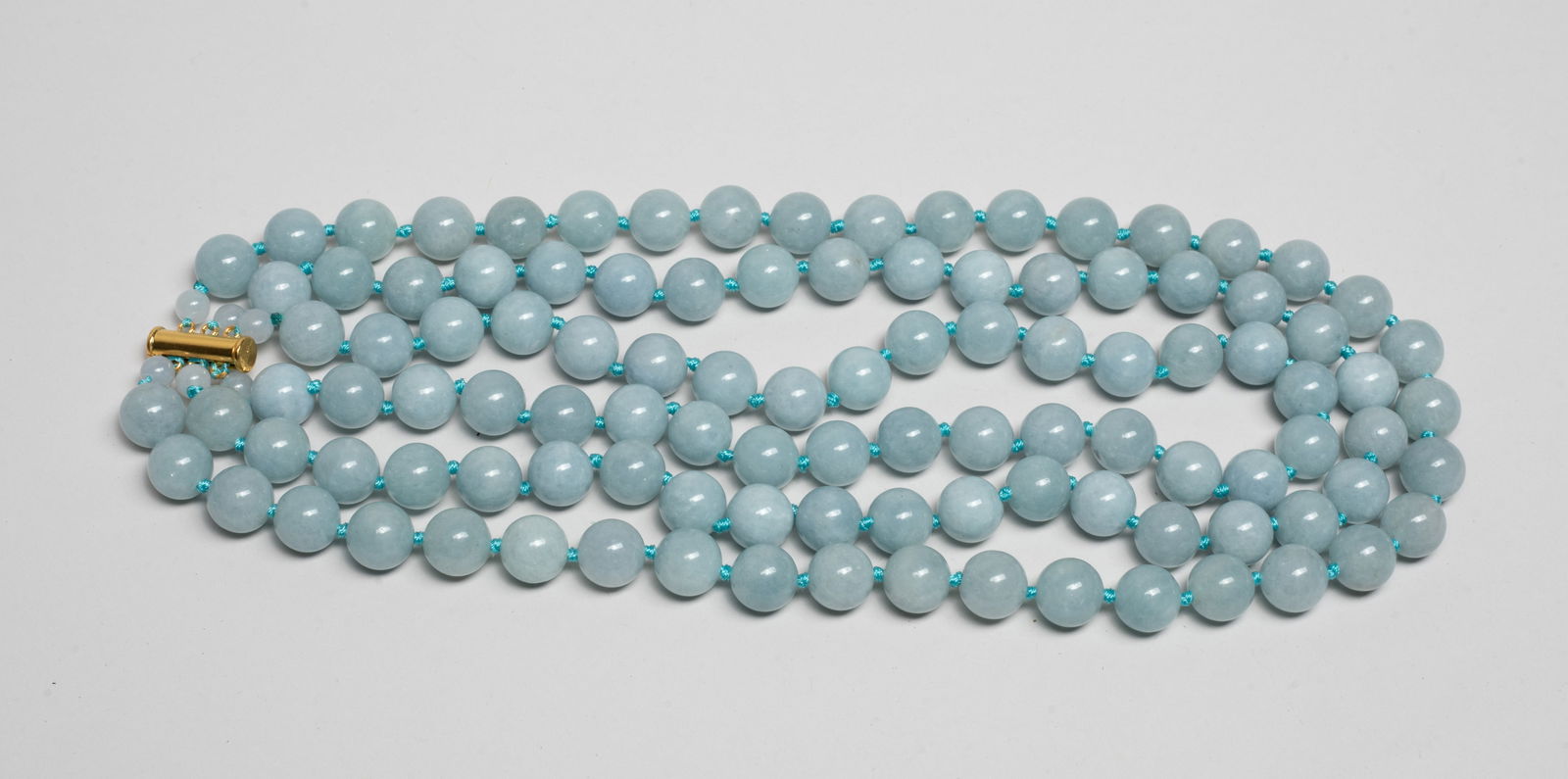 Designed Aquamarine Multi-strands Necklace: Collectible three-strand aquamarine carved bead necklace. Approx. 18inch L.