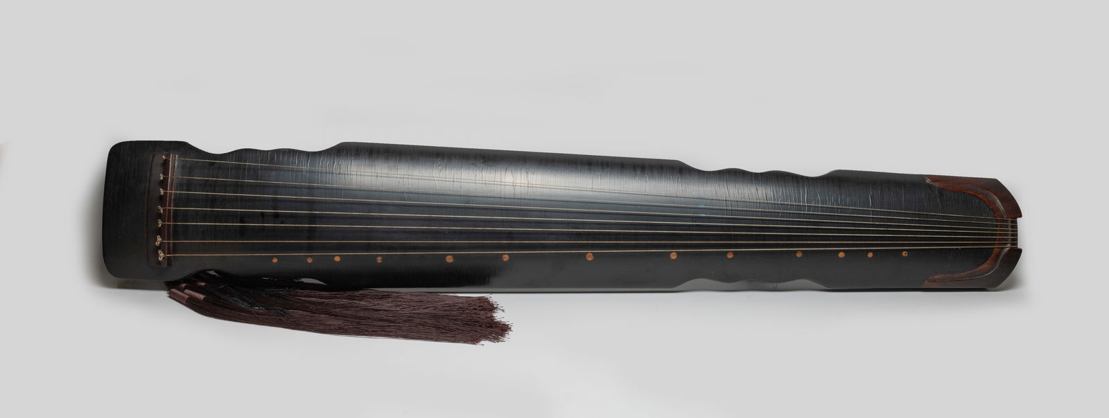 Estate Chinese Lacquer Guchen: Chinese lacquer guchen, decorated with dark-color tassel, with inscription on the underside. Approx. 48.3*7.6*2.6 inch.