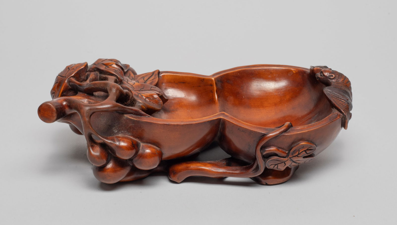 Estate Chinese Boxwood Brush Washer: Carved in double gourd shape with a bat ascending to the rim, surrounded by leafy stems and tendrils, the gnarled stem forming the base. Approx. 6.6*3.4*2.1 inch.