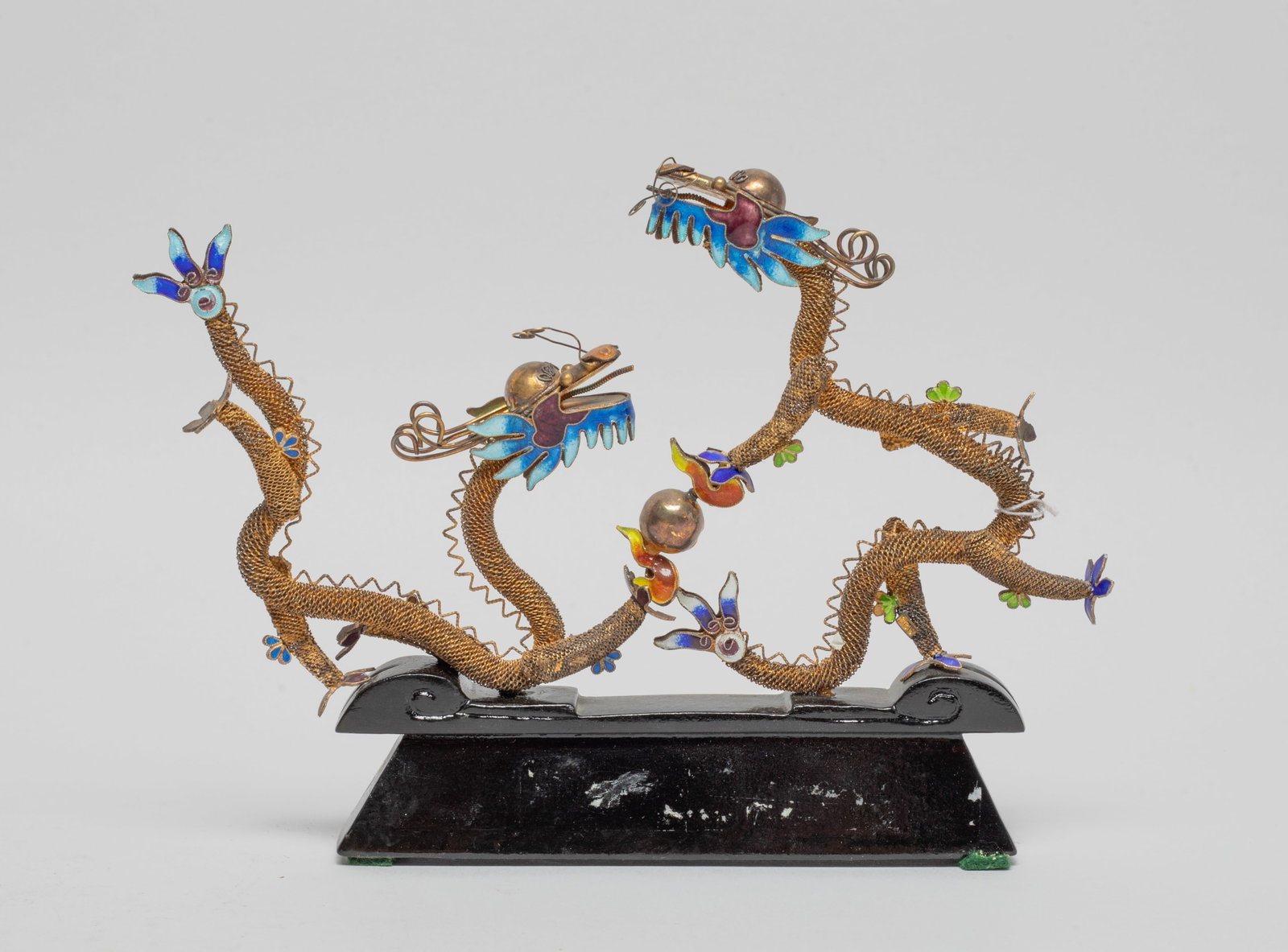 Chinese Gold on Silver Sculpture of Dragon: Moulded as a pair of dragons surrounding a ball, the dragons with reticulated sinuous body and the head, tail and paws applied blue and purple glaze, with stand. Approx. 6.7*4.7*0.8 inch (w/ stand). T