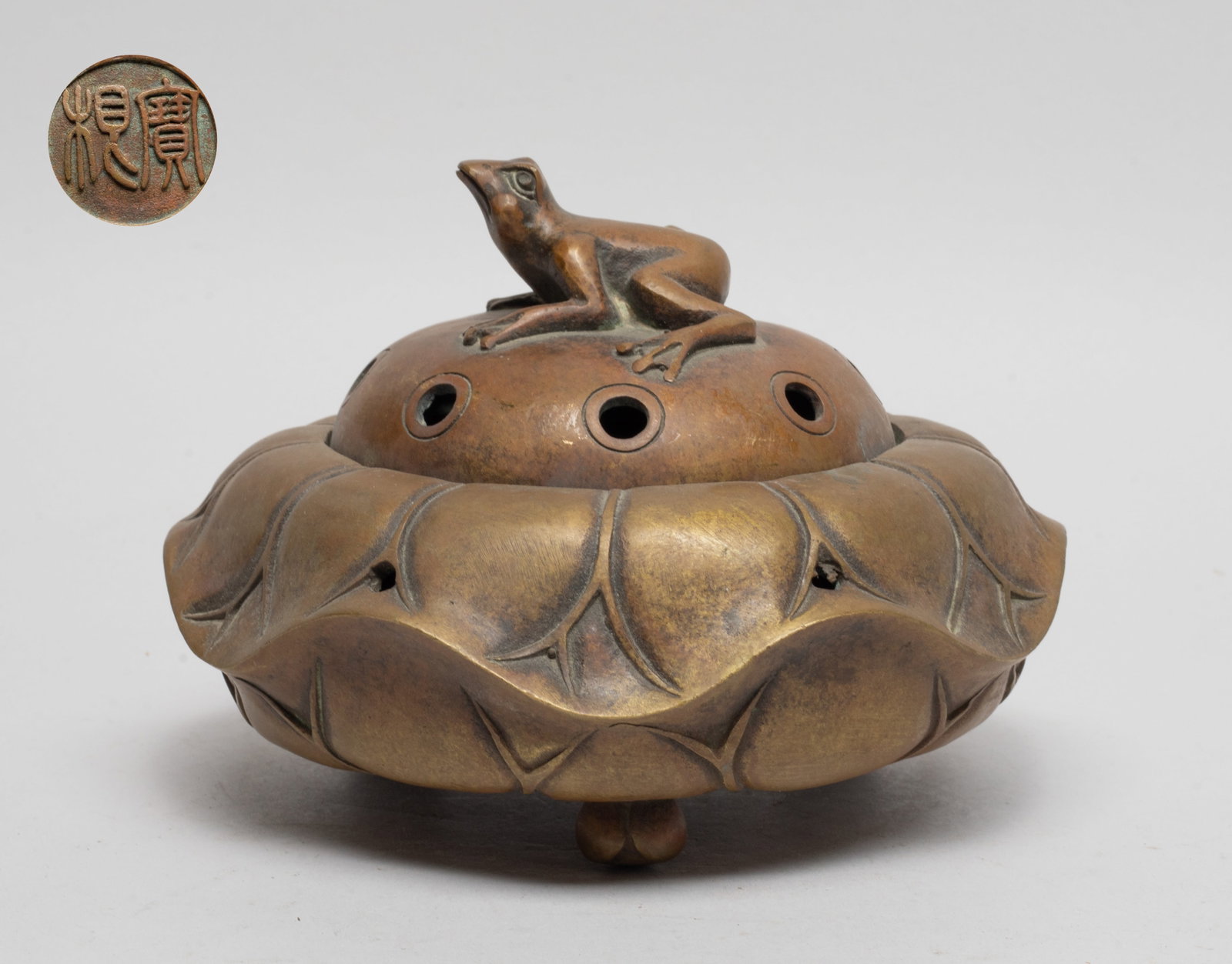 Collectible Chinese Lotus Form Bronze Censer: Moulded in special lotus form supported on three short feet, the lid drilled with circular apertures and set with a frog finial, the bottom carved with ac cirular mark enclosing two-characters. Approx