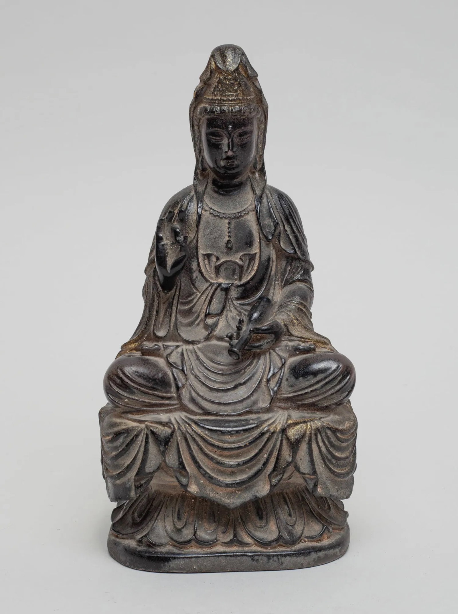 Collectible Chinese Sculpture of Buddha: The Buddha seated on a lotus base, the left hand holding a bottle and the right hand in vitarka mudra, dressed in a long flowing robe. Approx. 6.8-3.4-3 inch.