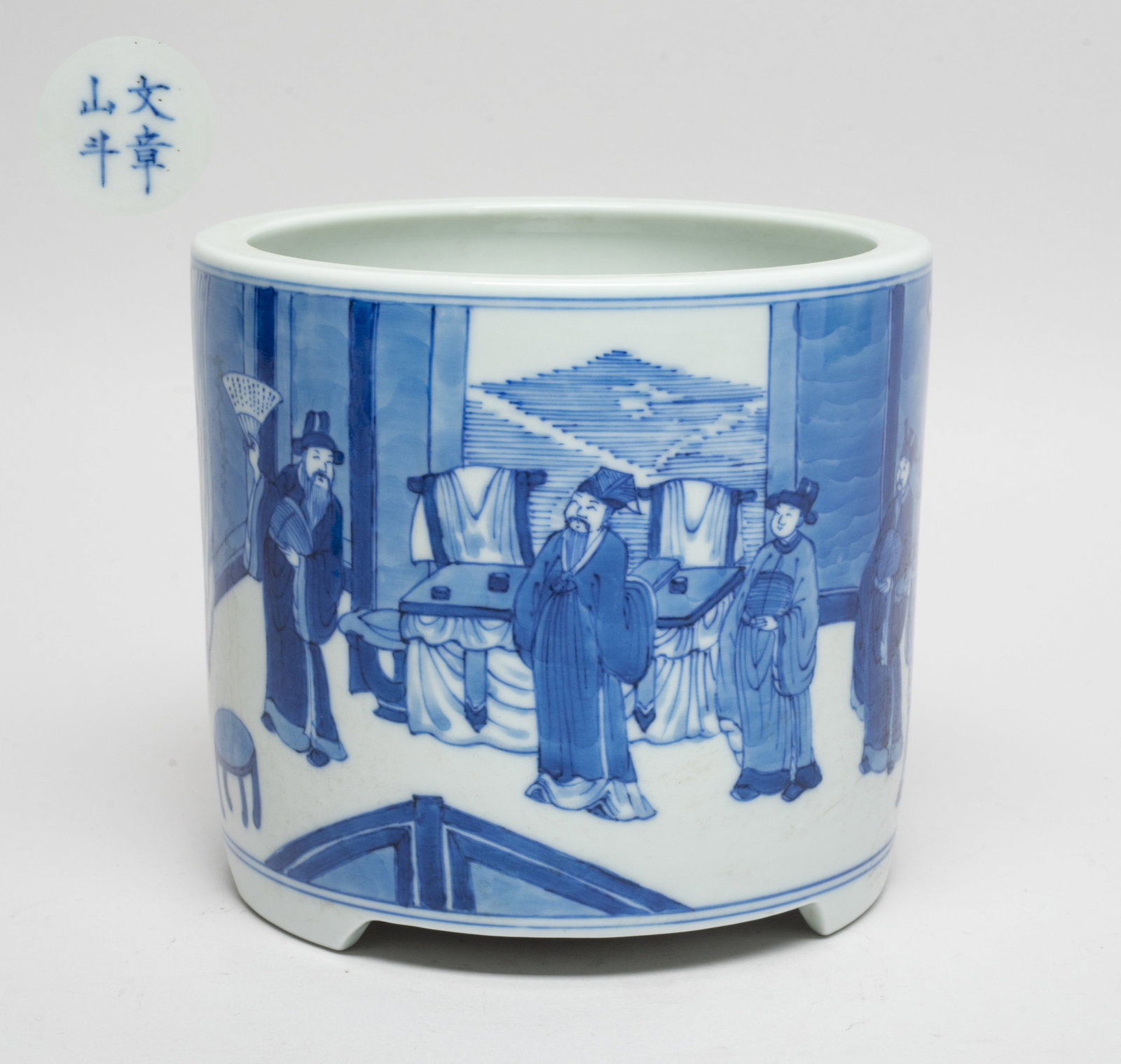 Chinese Blue & White Porcelain Brush Pot: Of cylindrical form with three short tapered feet, the exterior painted with an indoor scene of four standing scholars and their servant, the bottom marked with four characters. Approx. 5.6*5 inch.