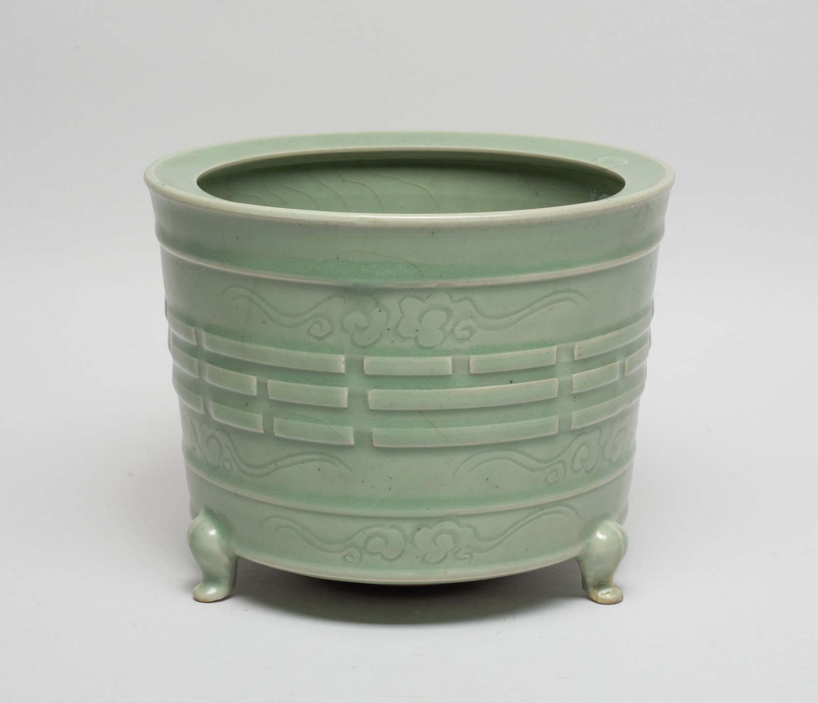 Large Chinese Longquan Porcelain Censer: The censer exterior carved in raised relief with Daoist Eight Trigrams, ground with scrolling clouds, covered overall in celadon glaze, all supported on three short cabriole legs. Approx. 7.7*6 inch.