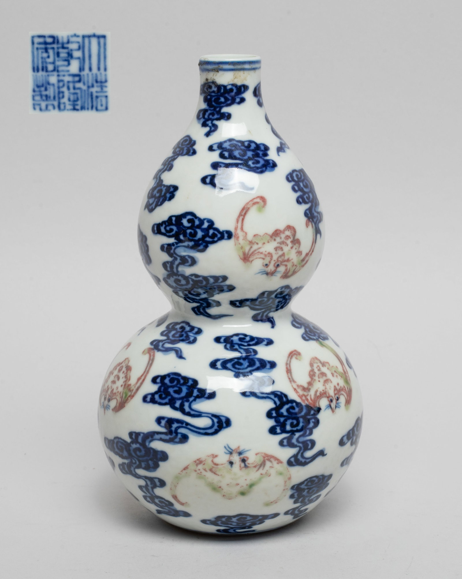 Chinese Export Porcelain Gourd Vase: Of double gourd form, the exterior painted with copper-red bats amidst cobalt-bleu scrolling clouds, the bottom inscribed with a six-character mark. Approx. 5.9*3.4 inch.