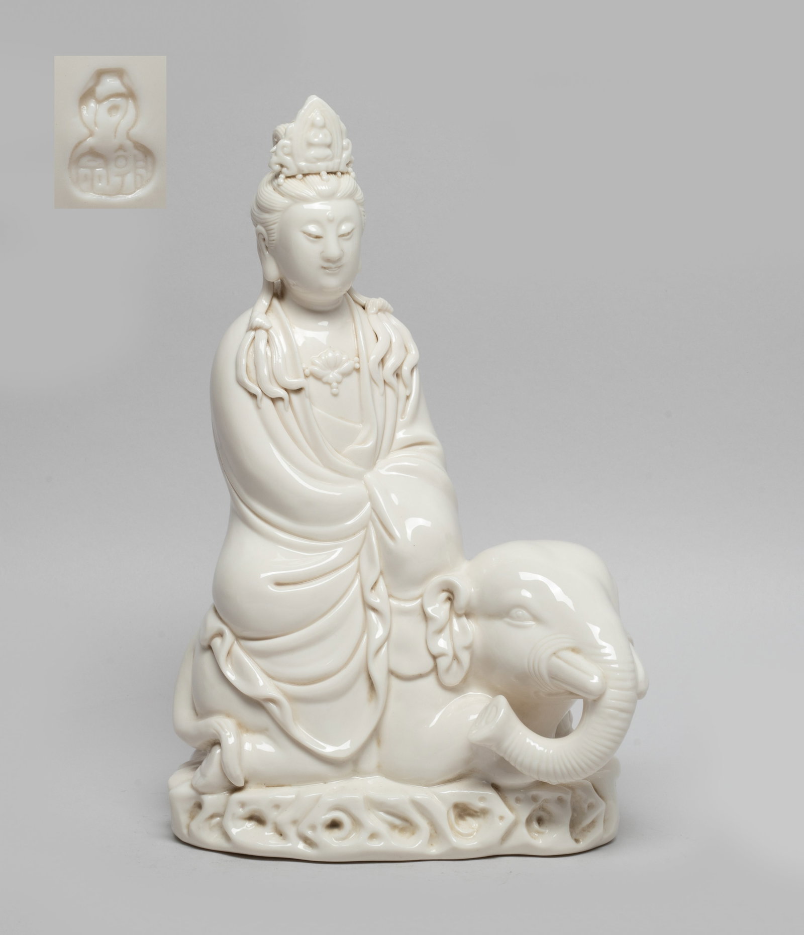 Chinese Blanc De Porcelain Sculpture: Moulded as Kuanyin seated on a recumbent elephant , wearing a loose-fitting robe and a lotus necklace, overall applied in creamy white glaze. Approx. 10*6.5*3.7 inch.