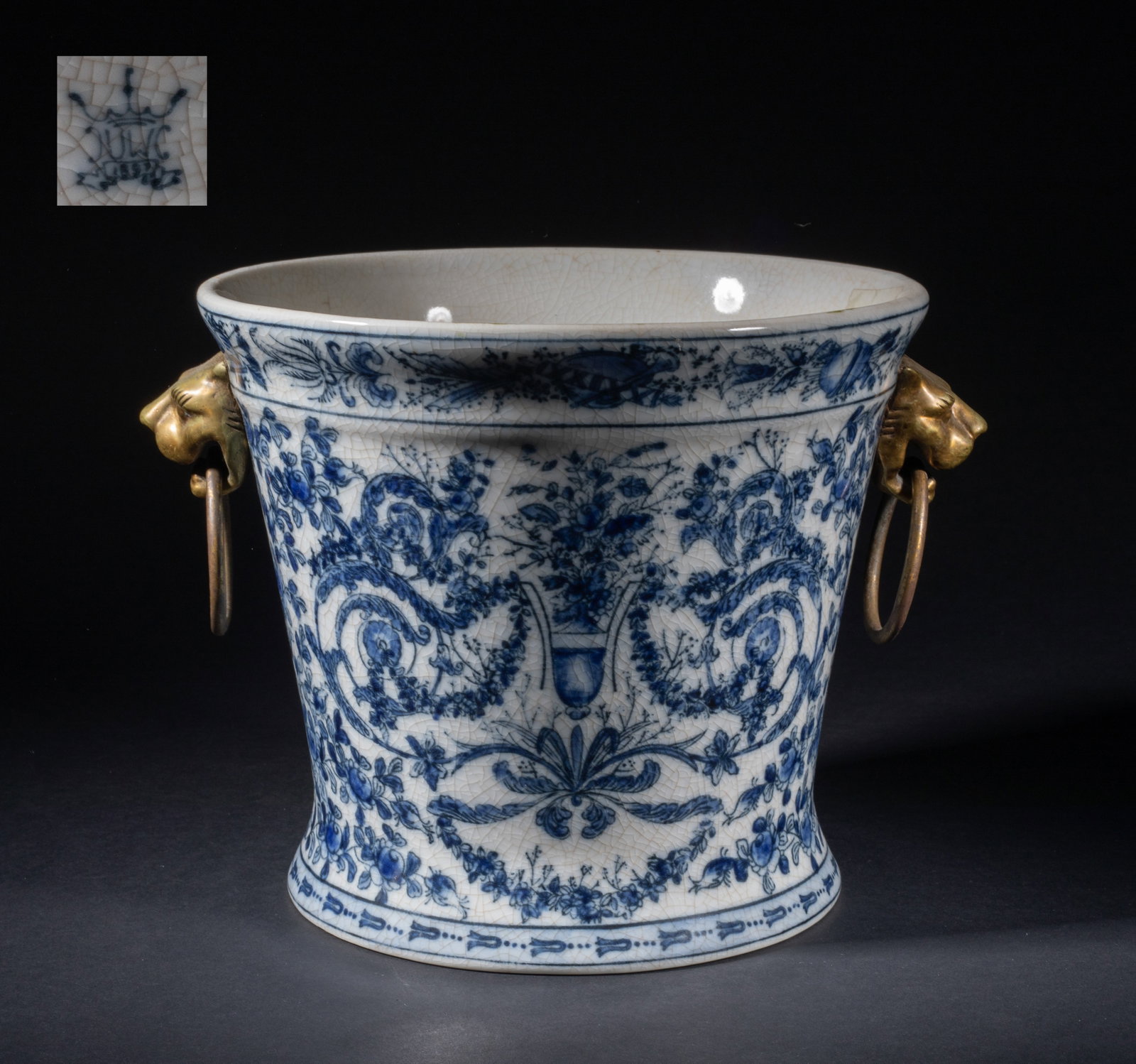 Vintage Porcelain Ice Pot: Of waisted form, the exterior decorated with dense floral pattern against crackled background, set with a pair of metal mask handles suspended with loops. Approx. 8.5*7.5 inch.