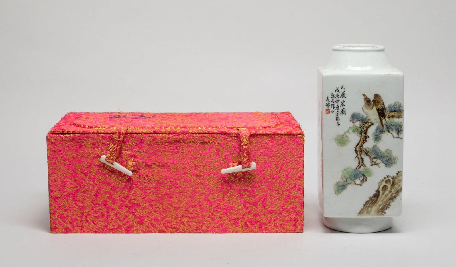 Chinese Export Famille Rose Porcelain Vase: Of tall square section with circular mouth and foot, one side painted with bird and pine tree, the reverse with bird and plum blossoms, inscribed with related passages on the other two sides, with box