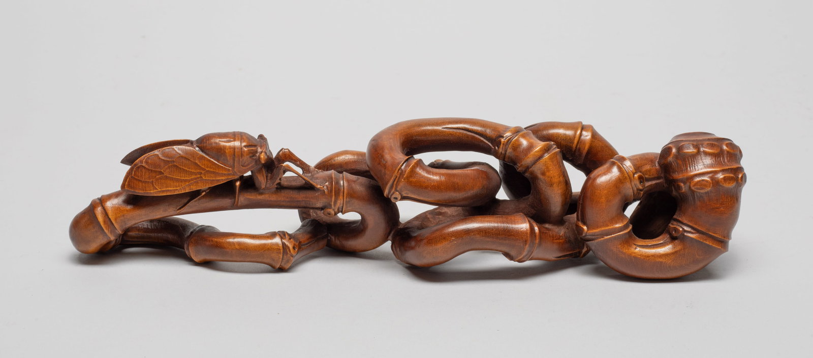 Chinese Wood Carved Table Sculpture: Naturalistically carved as twisted bamboo with a cicada. Approx. 9.7*2.3*2 inch.