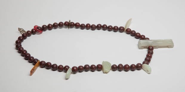 Estate Chinese Seed, Jade Mixed Prayer Beads: A long string of Chinese seed carved prayer beads, decorated with six jade toggles, wherein one of hook form, one carved of rabbit form, one carved of almond shape, one carved with archaic birds, and