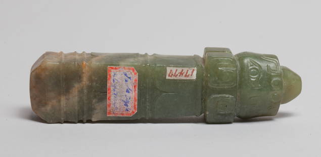 Chinese Russet Jade Mask Toggle: Special form Chinese jade toggle carved on the with masks at the end, drilled at the top for suspension, the stone of celadon tone with russet inclusions. Approx. 3.9*1*0.8 inch.
