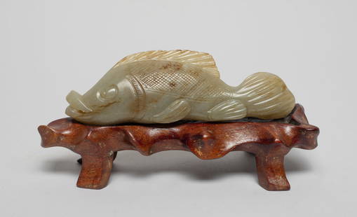 Chinese Jade Carved Fish Sculpture: Chinese russet jade carved fish, finely incised scale and tail, with a wood stand. Approx. 4.7*1.4*0.7 inch. The Estate of the Store Closed Sale in Little Tokyo, DTLA.