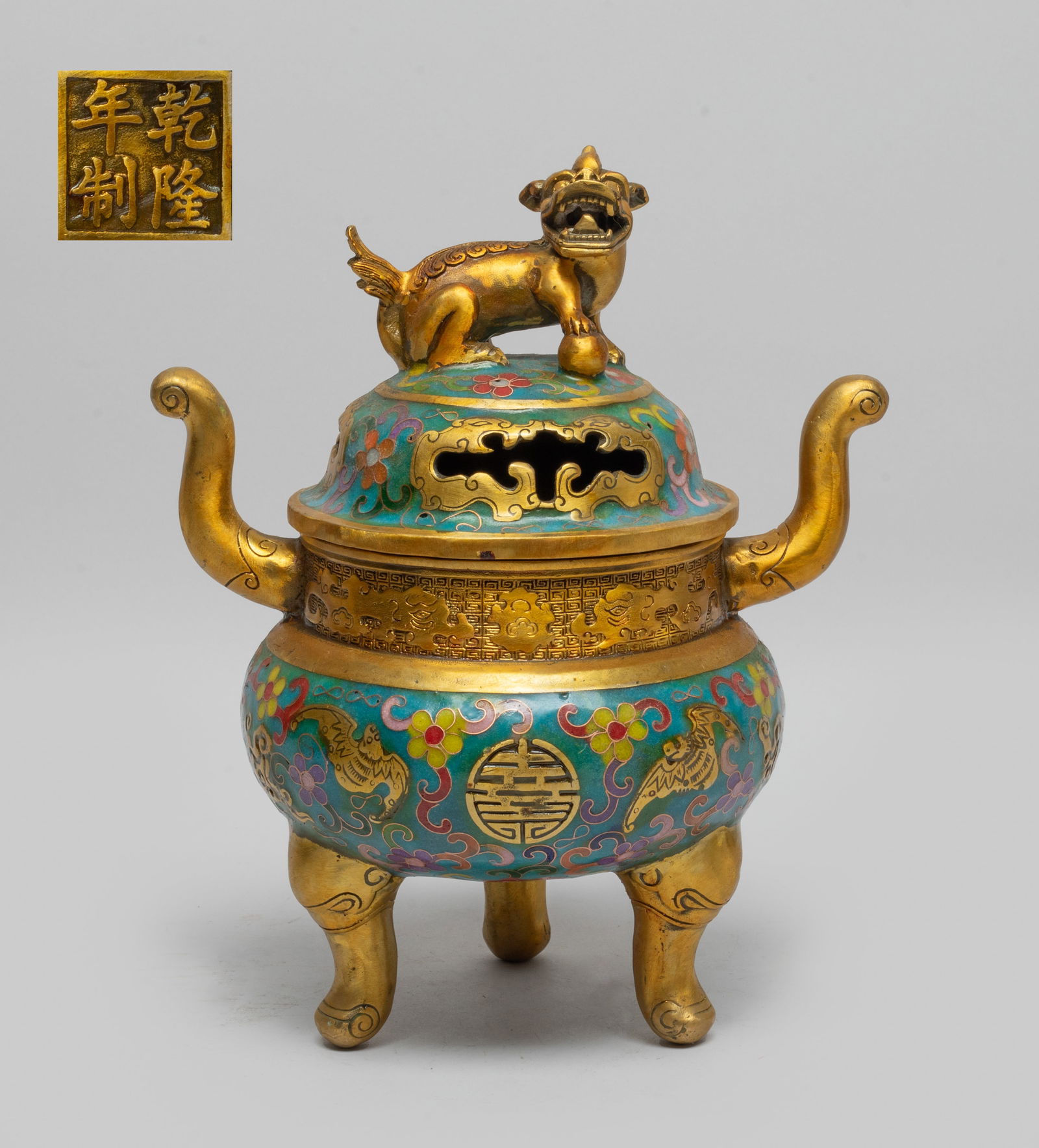 Estate Chinese Cloisonne Censer: The compressed globular body carved with bats and shou characters, enameled with flowers on turquoise blue background, rising to a cylindrical neck carved archaic beasts on leiwen ground, set on three