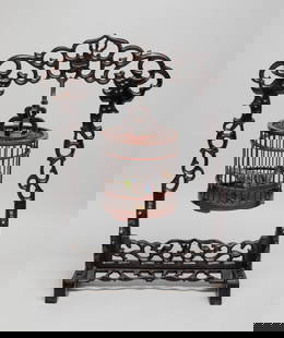 Estate Chinese Wood Table Cage: Chinese wood bird cage, with a cloisonne bird inside, suspended on a wood stand, carved in openwork with stylized dragons fighting over a 'pearl'. Approx. 13*8.5*4.5 inch. The Estate of the Store Clos