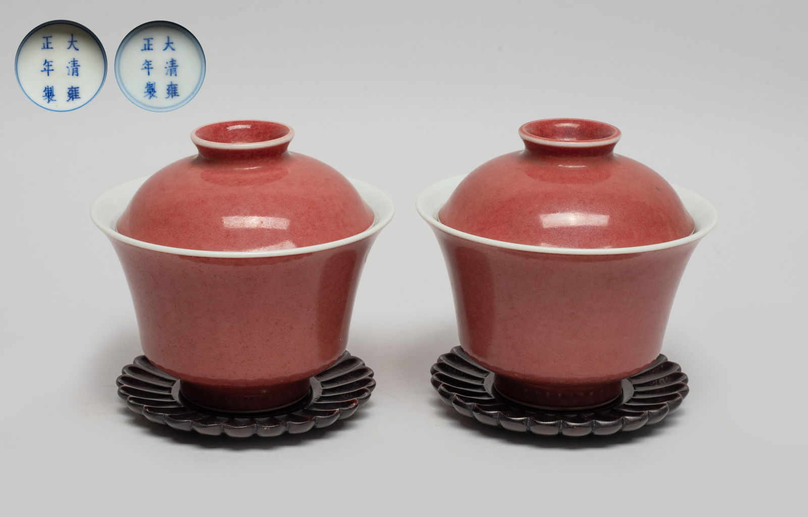 Estate Chinese Red Glazed Porcelain Tea Cups: Either tea cup body and lid exterior applied with red glaze, the bottom marked with six characters enclosed in double circles, with wood carved flower form saucers. Approx. 3.7*3.4 inch (w/o saucer).