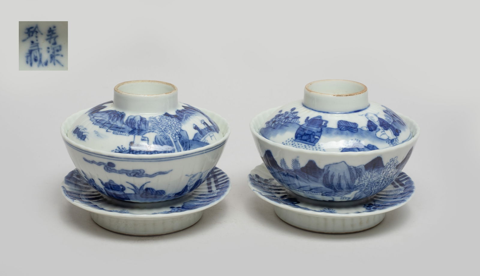Chinese Export Blue & White Porcelain Tea Cups: One cup body and lid exterior painted with two figures walking on a bridge in landscape, the other cup body and lid painted with boy boiling tea among flowers and rockery, the stands painted with tea