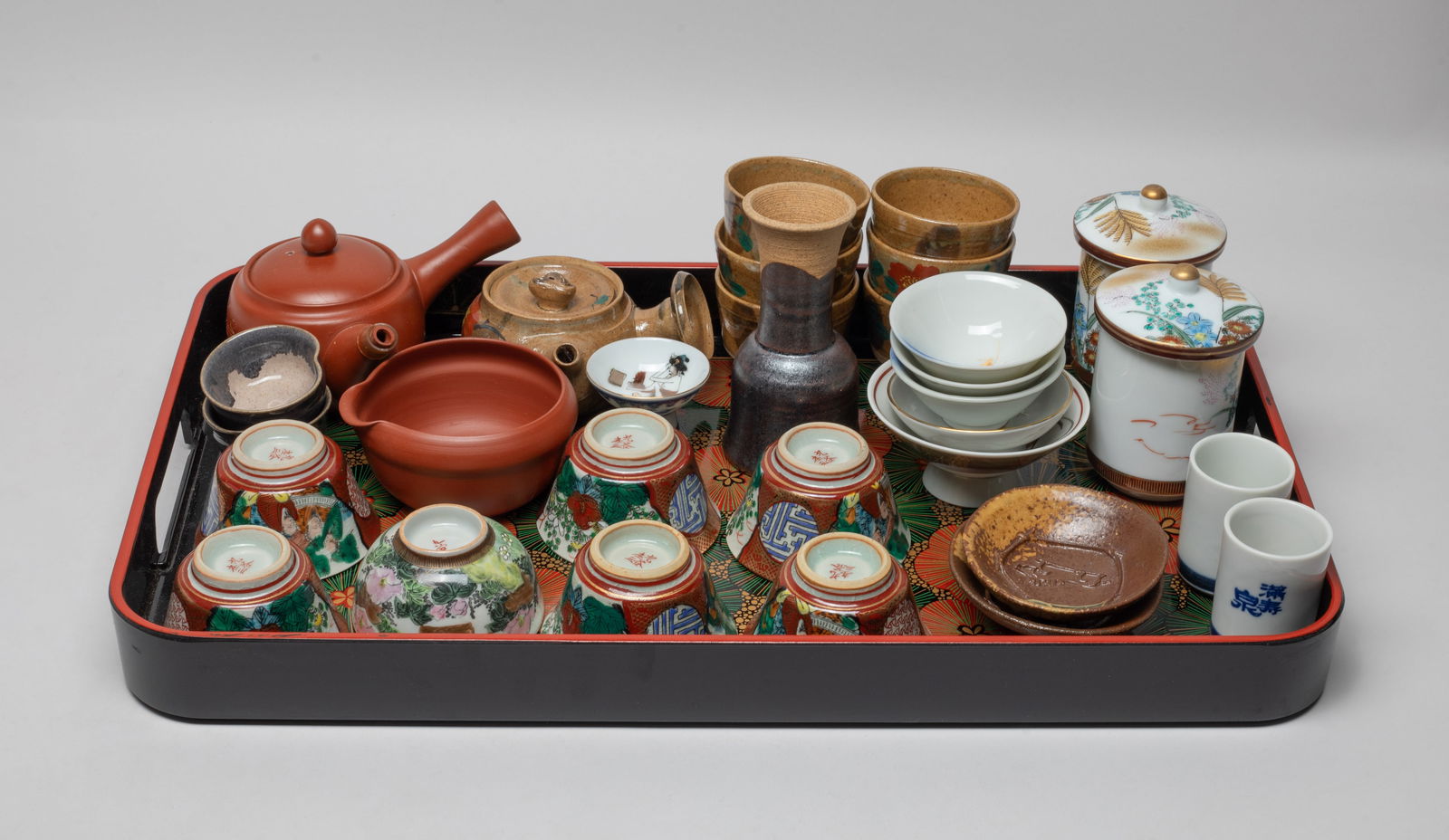 Estate Chinese/ Asian Porcelain Tea Sets: A large group of Chinese / Asian porcelain tea cups and tea pots, with a tray. Size varies.
