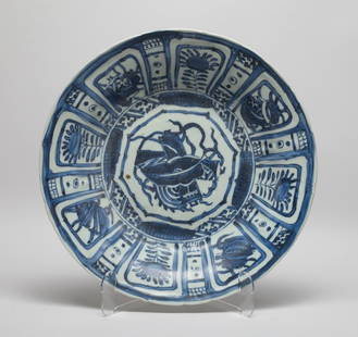 Large Chinese Shipwreck Form Porcelain Plate: The plate interior decorated with a large bloom enclosing flowers and traditional symbols, the exterior with a band of petals. Approx. 12.5*2.3 inch.