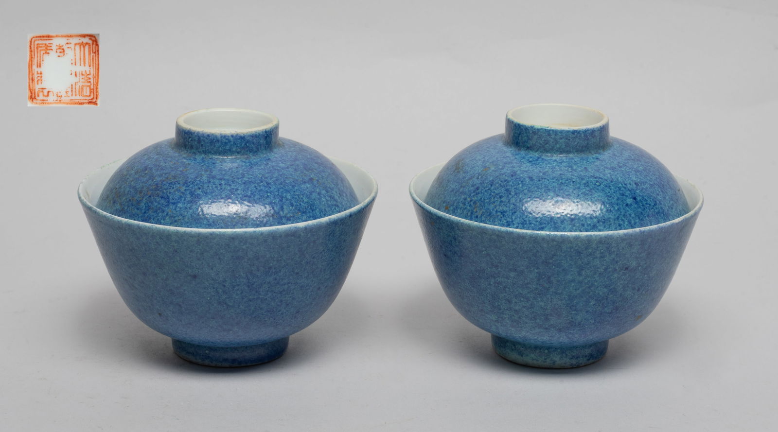 Pair Chinese Porcelain Tea Cups: Each tea cup body and lid exterior covered in mottled blue glaze, the cup bottom and the lid top inscribed with copper-red seal marks. Approx. 4.1*3.3 inch (each).
