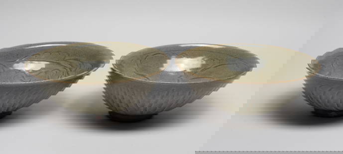 Two Chinese Shipwreck Type Porcelain Large Bowls: Both bowls interior well impressed in composed vine and lotus decoration, the exterior sides incised in a simple design of vertical stripes, covered in a viscous glaze pooling in varied hues of olive