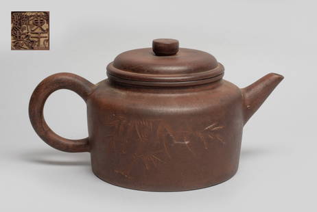 Chinese Yixing Zisha Tea Pot: The tea pot body incised with bamboo and inscribed with related poems, the lid interior with two marks and the bottom with a seal mark. Approx. 8.7*5.4*4.5 inch.