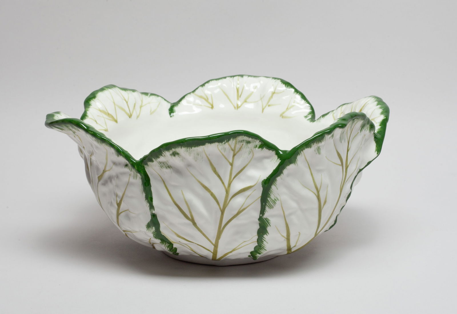 Large Tiffany Bone China Bowl: Collectible bone china centrpiece bowl, worked in overlapping leaves form, the bottom marked MADE IN ITALY EXCLUSIVELY FOR TIFFANY & CO. Approx. 10.2*4.5 inch.