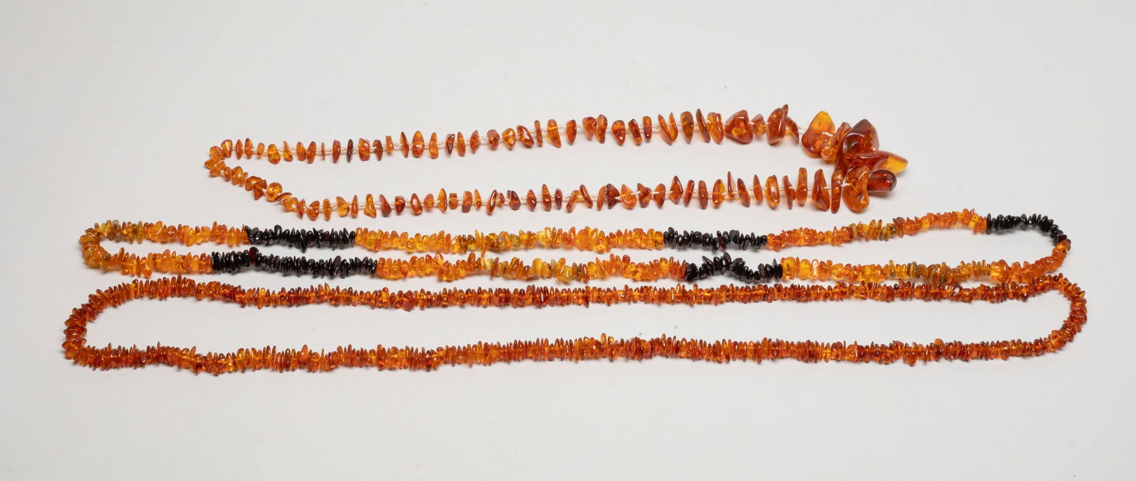 Vintage Nature Amber Necklaces: Three vintage nature amber carved nugget necklace. Approx. 125 gram (total weight), 38 inch L (longest)