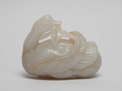 Chinese Russet Jade Sculpture of Goose: Naturalistically carved as a goose looking back and its beak holding a sprig of fruits of leaves, the stone of grayish white tone with russet inclusions. Approx. 3.2*2.5*1.7 inch.