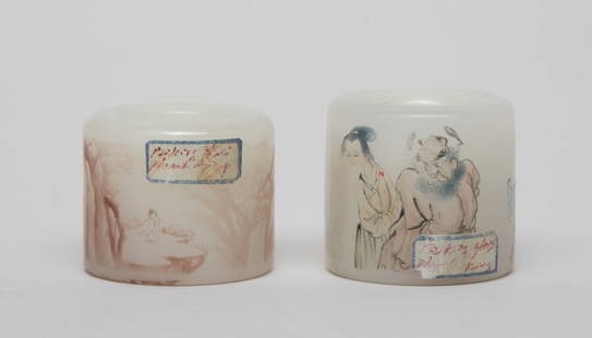 Two Chinese Peiking Glass Thumb Rings: Two white Peiking glass thumb rings, one painted with mountain landscape scene, the other painted with six figures and two bats, inscribed with related passages. Approx. 1.57*1.44 inch (larger). The E