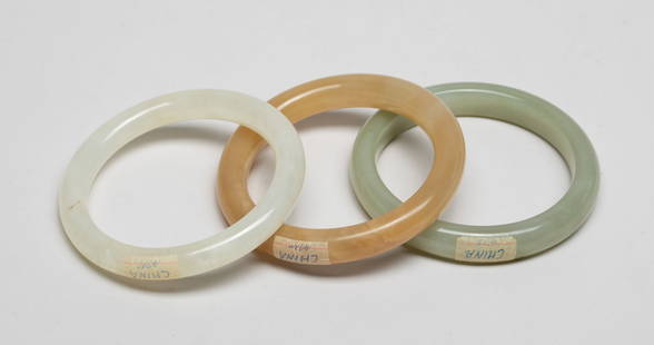 Estate Chinese Export Jade/ Hard Stone Bangles: Three Chinese jade / hard stone carved bangles. Approx. 2.95 inch outer diameter, 2.35 inch inner diameter (largest). The Estate of the Norman & Lisa, AZ
