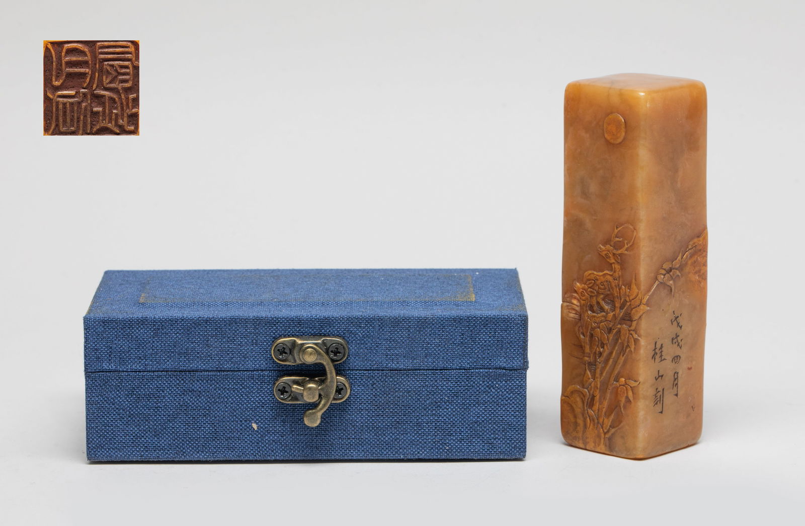 Large Chinese Shoushan Stone Seal: Of tall square section, the exterior carved in shallow relief with a deer among flowers and rockwork under distant moon, with box. Approx. 4.4*1.28*1.28 inch (w/o box).